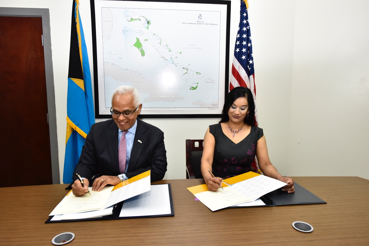 The Minister of Tourism, Hon. Dionisio D'Augilar and Ms. Manisha Singh, US Assistant Secretary of State, Bureau of Economic and Business Affairs signing the Air Transport Agreement between the Government of the United States of America and the Government 