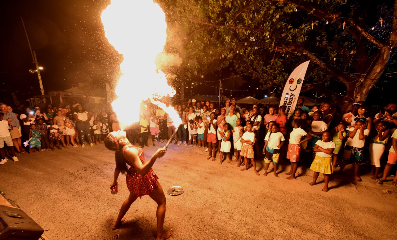 Festival Goers entertained by Fire Dancer Kieasha Poitier