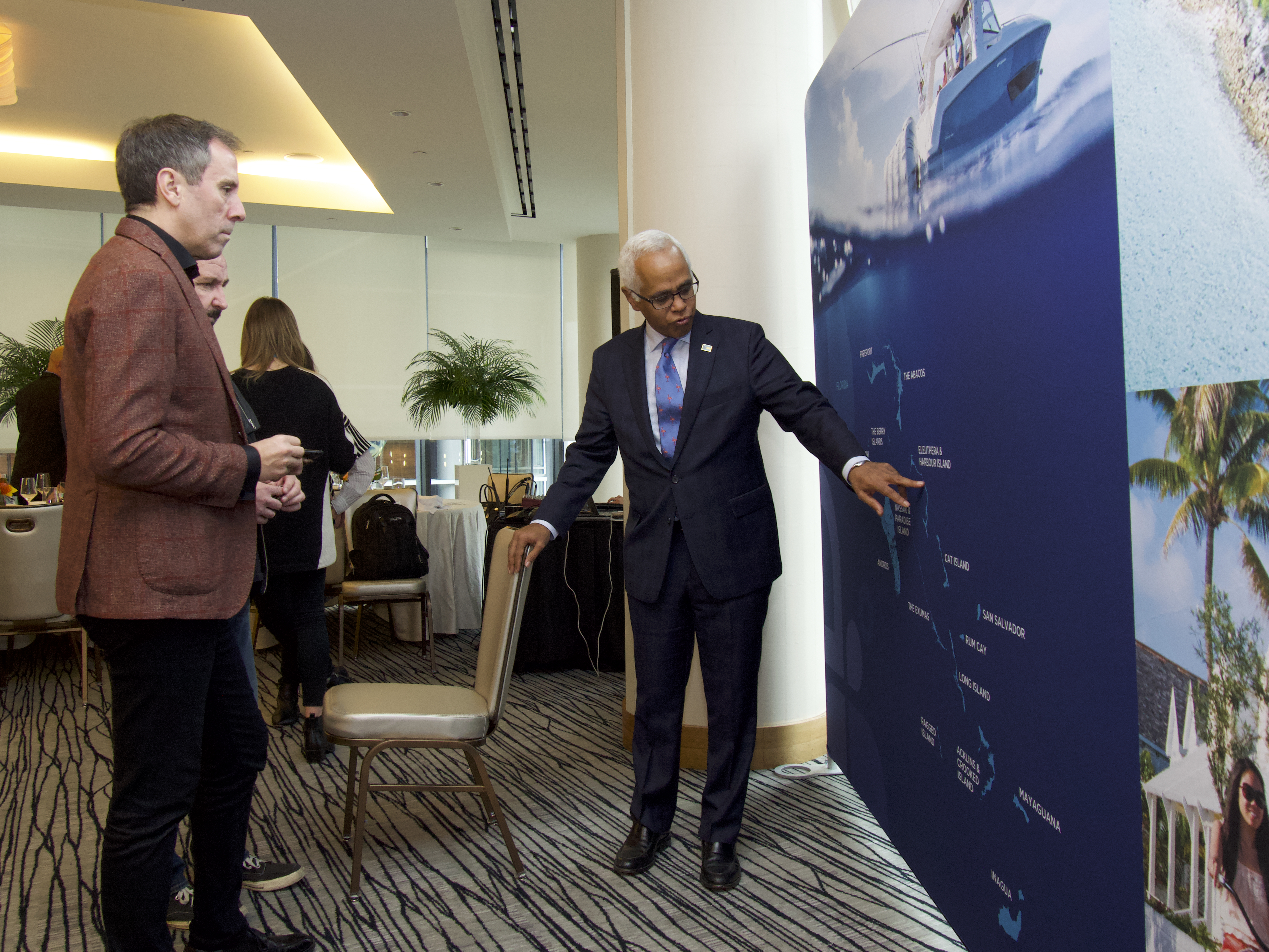 Minister educating media guests on the geography of The Bahamas at Vancouver Media event